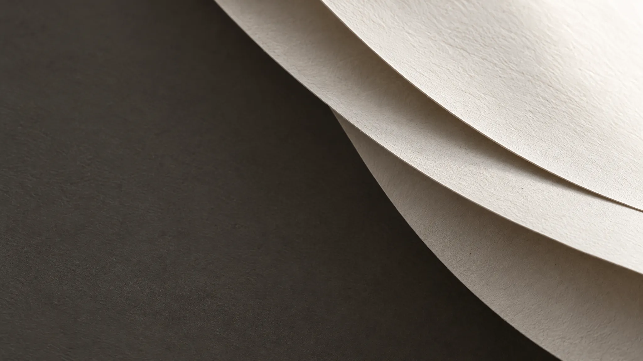 Composição abstrata de camadas de papel com luz lateral e sombras suaves